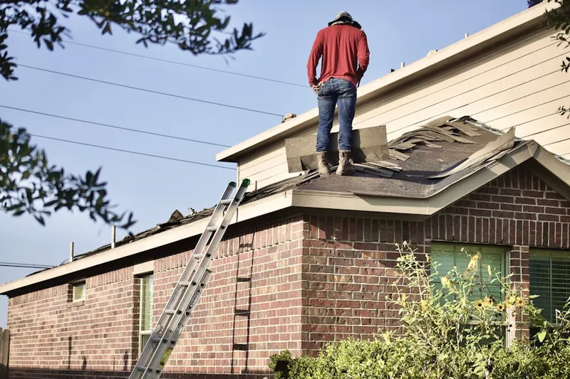 Professional roofer working on a residential roof in West Lanham Hills